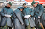 2008年2月4日下午，广州火车站，交通已开始好转，一队队旅客正在战士的疏导下有序进站。连续几天全天候的执勤，让每个战士的脸上都挂着疲惫，四名战士站着睡着了。